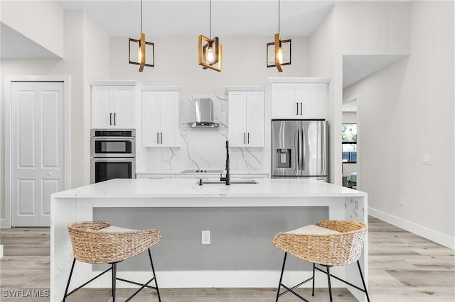 224 NW 14th Pl, Cape Coral, FL 33993 - kitchen featuring stainless steel appliances, a sink, wall chimney exhaust hood, and white cabinets