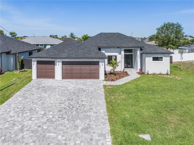 224 NW 14th Pl, Cape Coral, FL 33993 - view of front of house featuring decorative driveway, a front lawn, an attached garage, a shingled roof, and stucco siding