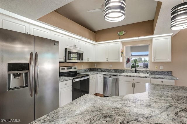 2142 NE 27th Ter, Cape Coral, FL 33909 - kitchen featuring stainless steel appliances, a sink, white cabinets, a ceiling fan, and light stone countertops