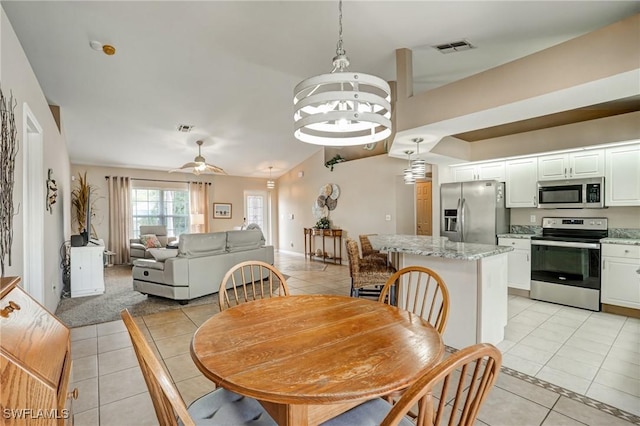 2142 NE 27th Ter, Cape Coral, FL 33909 - dining space with light tile patterned flooring, a chandelier, inlaid floor details, and a ceiling fan