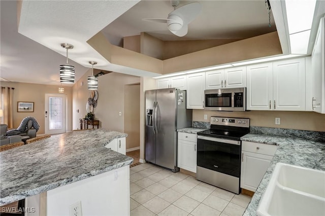 2142 NE 27th Ter, Cape Coral, FL 33909 - kitchen featuring stainless steel appliances, white cabinetry, light tile patterned flooring, ceiling fan, and hanging light fixtures