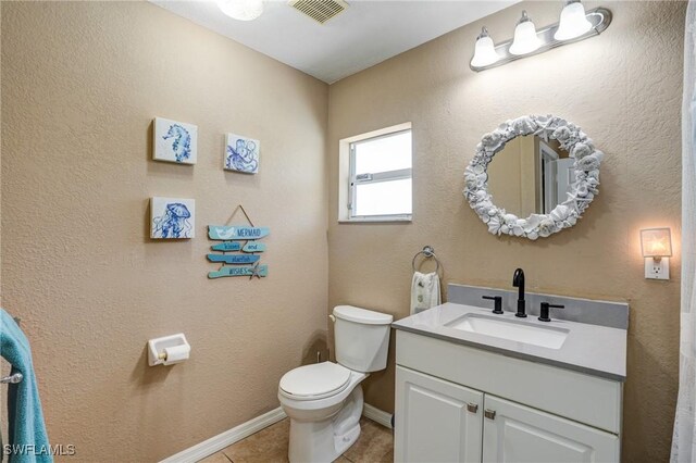 2142 NE 27th Ter, Cape Coral, FL 33909 - bathroom featuring toilet, vanity, tile patterned floors, and baseboards