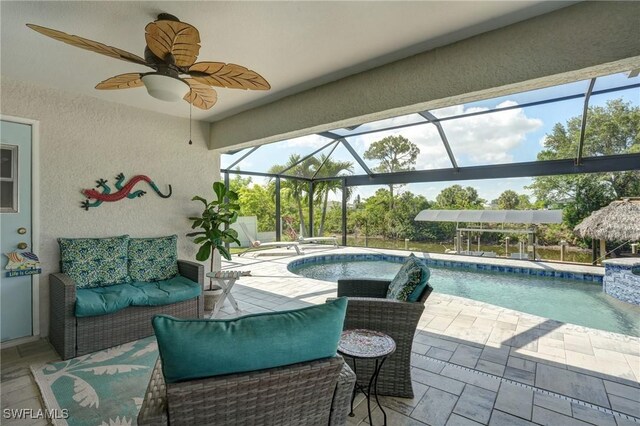 2142 NE 27th Ter, Cape Coral, FL 33909 - swimming pool featuring an outdoor hangout area, a patio area, and a ceiling fan