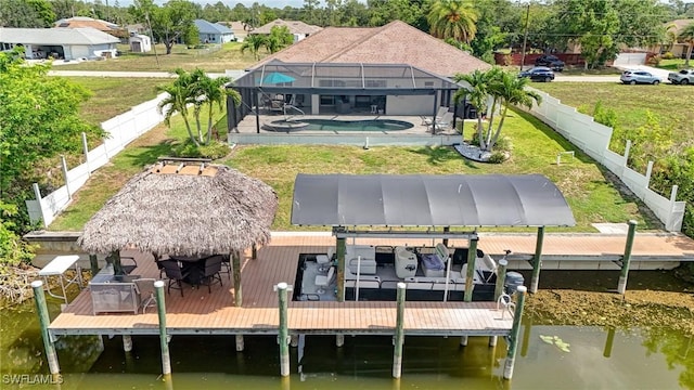 2142 NE 27th Ter, Cape Coral, FL 33909 - back of house with an outdoor pool, boat lift, and a water view