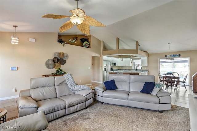 2142 NE 27th Ter, Cape Coral, FL 33909 - living room with a ceiling fan, baseboards, light tile patterned flooring, and high vaulted ceiling