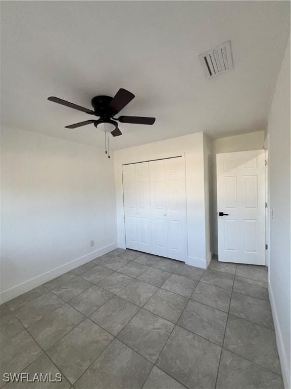 1412/1414 W 12th St, Lehigh Acres, FL 33972 - unfurnished bedroom featuring tile patterned flooring, baseboards, a closet, and ceiling fan