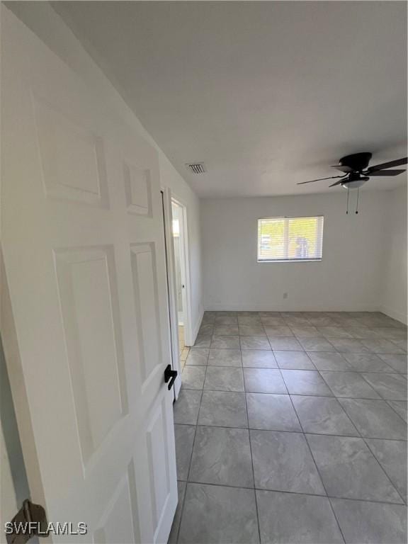 1412/1414 W 12th St, Lehigh Acres, FL 33972 - empty room featuring ceiling fan, light tile patterned flooring, and baseboards
