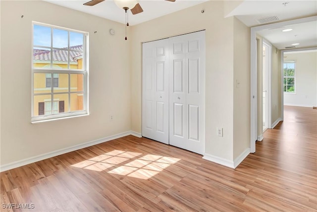 4135 Residence Dr Unit 618, Fort Myers, FL 33901 - unfurnished bedroom featuring light wood-style flooring, baseboards, a closet, and ceiling fan
