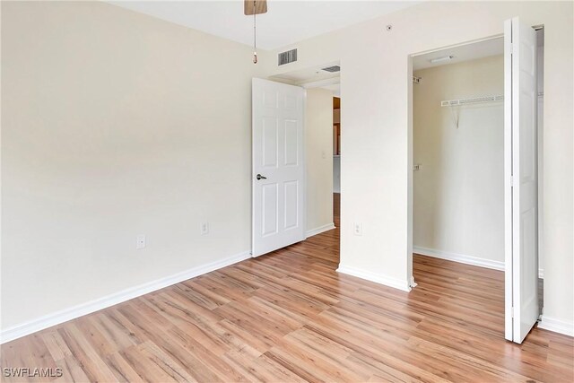 4135 Residence Dr Unit 618, Fort Myers, FL 33901 - unfurnished bedroom featuring light wood-style floors, baseboards, and a closet