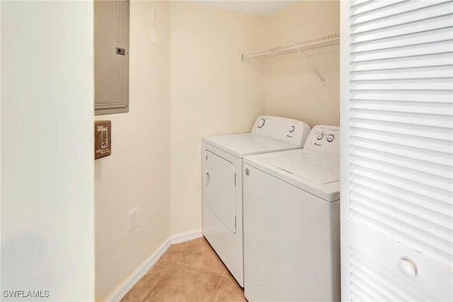 4135 Residence Dr Unit 618, Fort Myers, FL 33901 - laundry area featuring washing machine and clothes dryer, light tile patterned floors, electric panel, and baseboards
