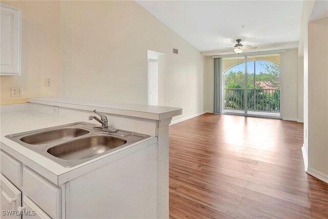 4135 Residence Dr Unit 618, Fort Myers, FL 33901 - kitchen featuring a sink, ceiling fan, lofted ceiling, wood finished floors, and baseboards