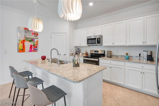 2131 Hamlin St, Naples, FL 34120 - kitchen featuring appliances with stainless steel finishes, a sink, a breakfast bar, crown molding, and light tile patterned floors