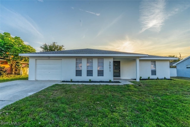3091 52nd St SW, Naples, FL 34116 - view of front of property featuring a garage, driveway, stucco siding, and a front yard