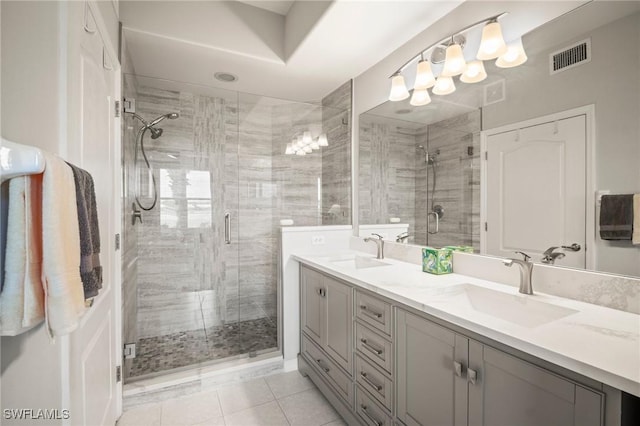 23581 Sandycreek Ter Unit 1107, Estero, FL 34135 - full bathroom with double vanity, a shower stall, and tile patterned flooring