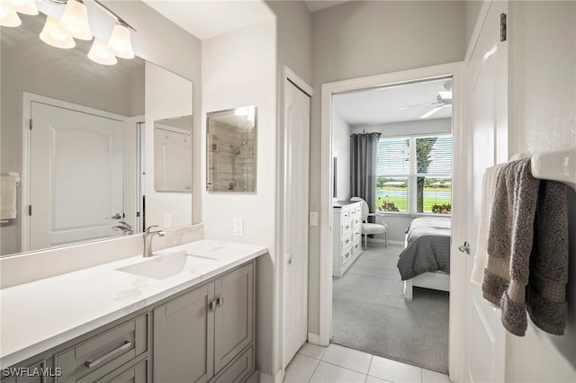 23581 Sandycreek Ter Unit 1107, Estero, FL 34135 - bathroom featuring connected bathroom, vanity, tile patterned flooring, and a ceiling fan