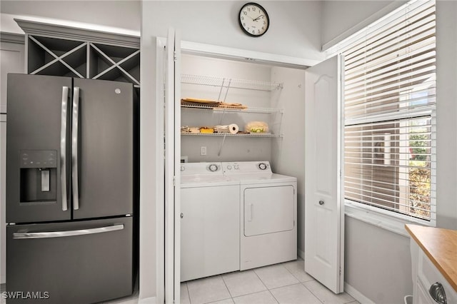 23581 Sandycreek Ter Unit 1107, Estero, FL 34135 - laundry room with washer and clothes dryer, light tile patterned floors, and baseboards