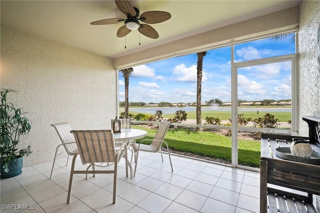 23581 Sandycreek Ter Unit 1107, Estero, FL 34135 - sunroom featuring a textured wall, a water view, plenty of natural light, and tile patterned flooring