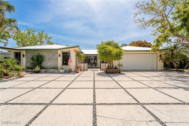 155 Donna Ct, Punta Gorda, FL 33950 - view of front facade featuring stucco siding, a garage, metal roof, and driveway