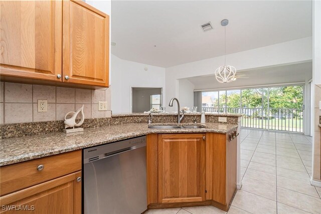 5135 Cobble Creek Ct Unit 204, Naples, FL 34110 - kitchen with dishwasher, a sink, a peninsula, light stone countertops, and light tile patterned floors