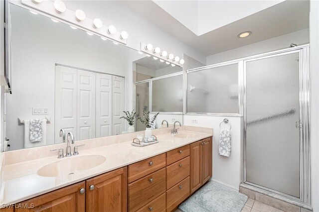 5135 Cobble Creek Ct Unit 204, Naples, FL 34110 - bathroom featuring double vanity, a stall shower, tile patterned floors, and recessed lighting