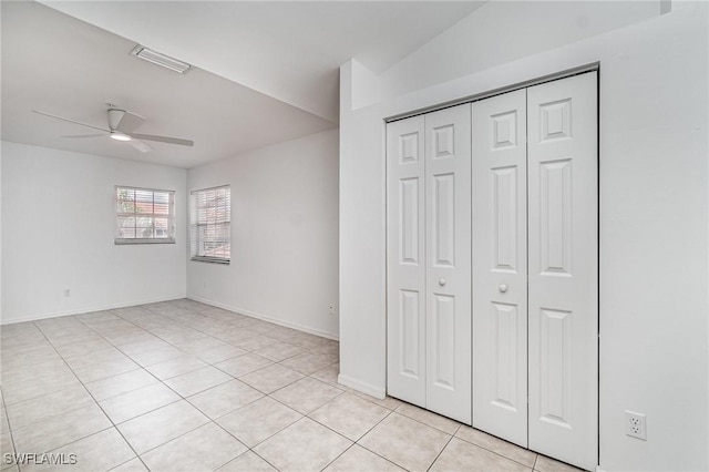 5135 Cobble Creek Ct Unit 204, Naples, FL 34110 - unfurnished bedroom with light tile patterned flooring, a closet, baseboards, and ceiling fan