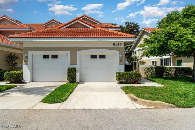 5135 Cobble Creek Ct Unit 204, Naples, FL 34110 - mediterranean / spanish home with driveway, an attached garage, stucco siding, and a tile roof