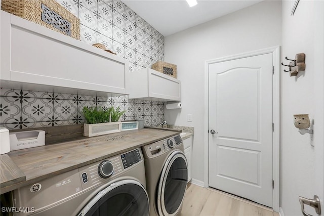 17476 Ashcomb Way, Estero, FL 33928 - washroom with cabinet space, washer and dryer, and light wood-type flooring