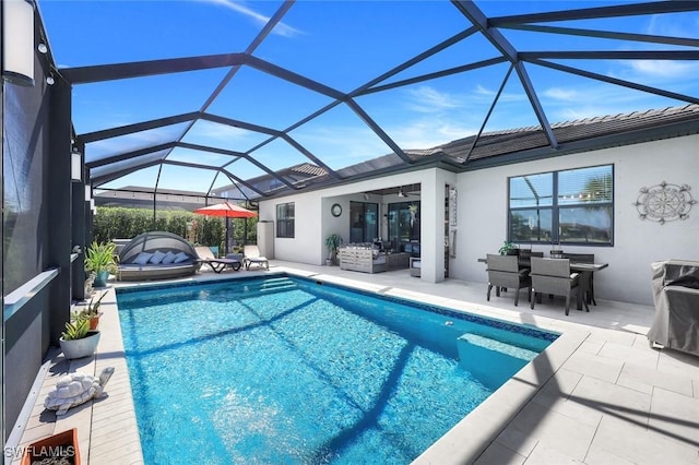 17476 Ashcomb Way, Estero, FL 33928 - swimming pool with a patio area, ceiling fan, outdoor dining area, and glass enclosure