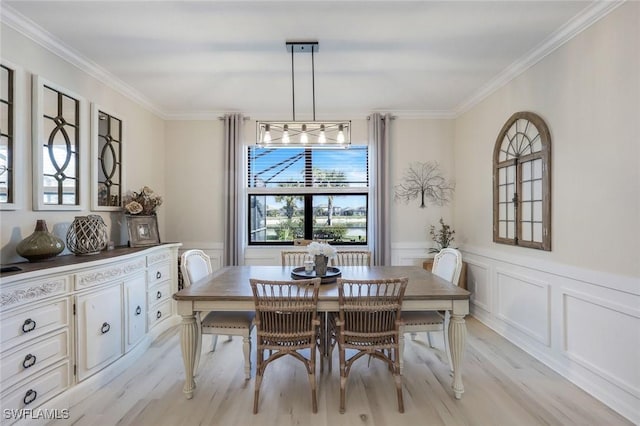 17476 Ashcomb Way, Estero, FL 33928 - dining room with light wood-style flooring, ornamental molding, a decorative wall, and wainscoting