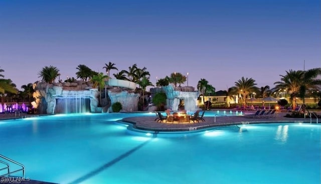 17476 Ashcomb Way, Estero, FL 33928 - pool at dusk with a community pool and a patio