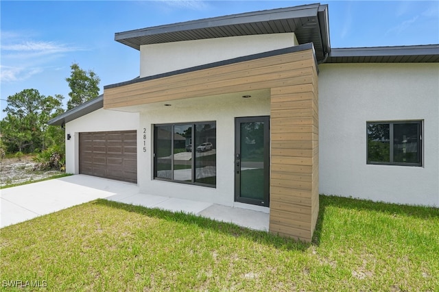 2815 45th St W, Lehigh Acres, FL 33971 - view of property exterior featuring stucco siding, concrete driveway, and a yard