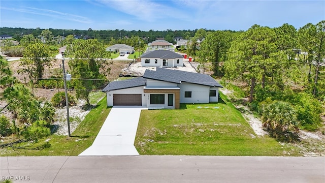 2815 45th St W, Lehigh Acres, FL 33971 - view of front of house featuring an attached garage, driveway, a front lawn, and stucco siding