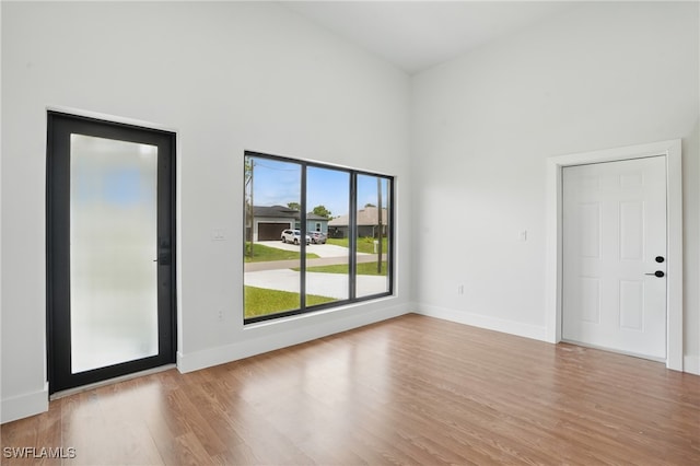 2815 45th St W, Lehigh Acres, FL 33971 - spare room with wood finished floors, a towering ceiling, and baseboards