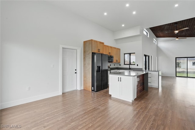 2815 45th St W, Lehigh Acres, FL 33971 - kitchen with fridge with ice dispenser, open floor plan, healthy amount of natural light, ceiling fan, and a high ceiling
