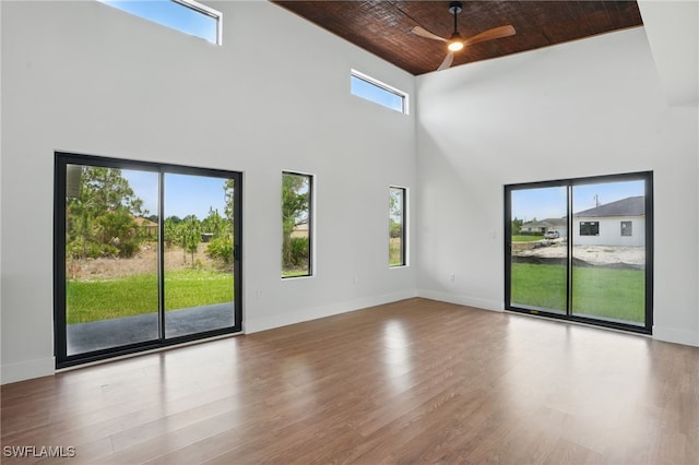 2815 45th St W, Lehigh Acres, FL 33971 - spare room featuring a towering ceiling, ceiling fan, wood finished floors, wood ceiling, and baseboards