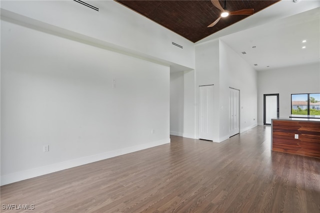 2815 45th St W, Lehigh Acres, FL 33971 - unfurnished living room with high vaulted ceiling, a ceiling fan, wood finished floors, and baseboards