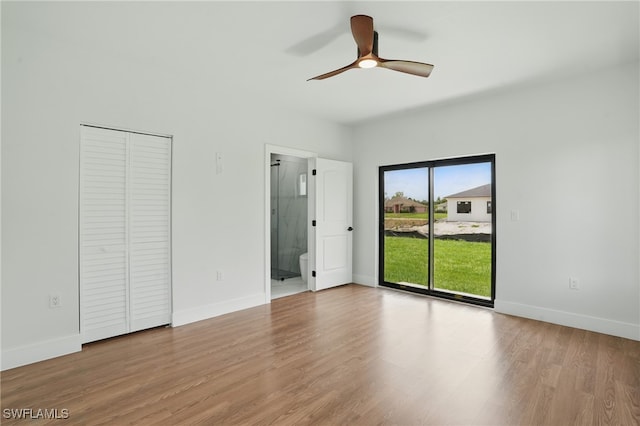 2815 45th St W, Lehigh Acres, FL 33971 - unfurnished bedroom with access to exterior, wood finished floors, and baseboards