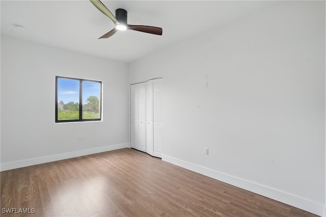 2815 45th St W, Lehigh Acres, FL 33971 - unfurnished bedroom with wood finished floors, baseboards, a closet, and ceiling fan