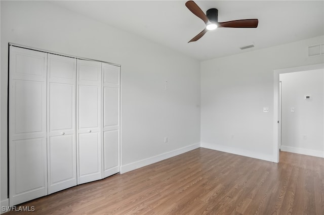 2815 45th St W, Lehigh Acres, FL 33971 - unfurnished bedroom featuring light wood-style flooring, baseboards, a closet, and ceiling fan
