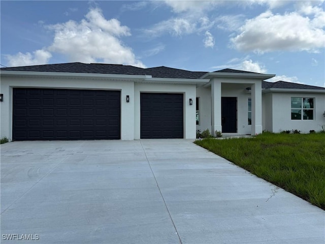 1837 NE 23rd St, Cape Coral, FL 33909 - prairie-style house featuring an attached garage, driveway, and stucco siding