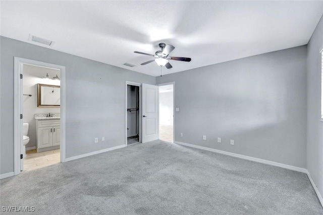13820 2nd St, Fort Myers, FL 33905 - unfurnished bedroom featuring light carpet, baseboards, a sink, and ensuite bath