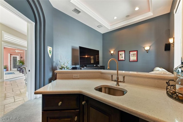 4409 Crews Ct, Port Charlotte, FL 33952 - kitchen with a sink, stone tile floors, light stone countertops, a raised ceiling, and dark brown cabinets
