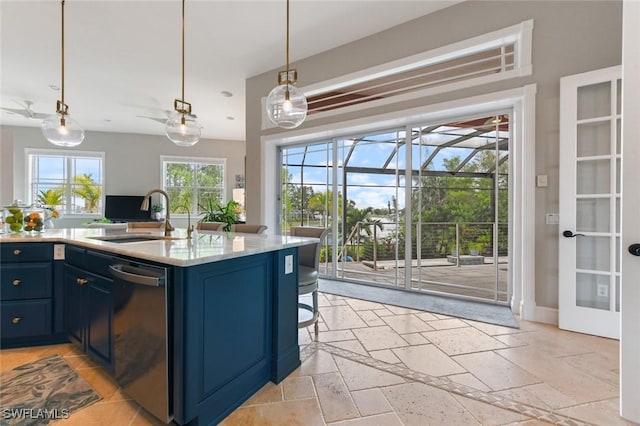 4409 Crews Ct, Port Charlotte, FL 33952 - kitchen with dishwasher, a sink, blue cabinets, stone tile flooring, and pendant lighting