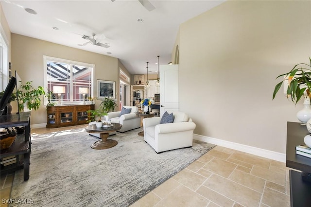 4409 Crews Ct, Port Charlotte, FL 33952 - living room with baseboards, ceiling fan, and stone tile floors