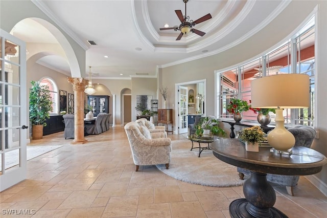 4409 Crews Ct, Port Charlotte, FL 33952 - living area with ornamental molding, arched walkways, stone tile floors, a ceiling fan, and ornate columns