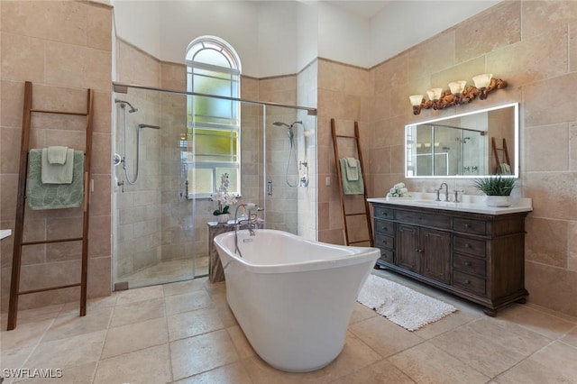 4409 Crews Ct, Port Charlotte, FL 33952 - full bathroom featuring tile walls, a stall shower, vanity, a freestanding bath, and tile patterned floors