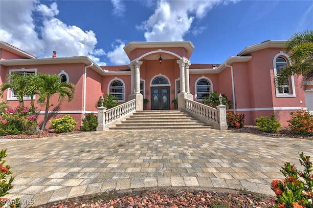 4409 Crews Ct, Port Charlotte, FL 33952 - mediterranean / spanish-style home with stucco siding and french doors
