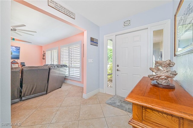 1826 SE 6th Ave, Cape Coral, FL 33990 - foyer entrance featuring healthy amount of natural light, a ceiling fan, light tile patterned floors, vaulted ceiling, and baseboards