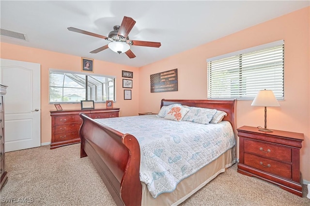 1826 SE 6th Ave, Cape Coral, FL 33990 - bedroom with multiple windows, light carpet, and a ceiling fan