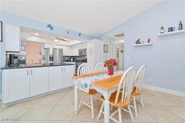 1826 SE 6th Ave, Cape Coral, FL 33990 - dining area with light tile patterned floors, a raised ceiling, and baseboards